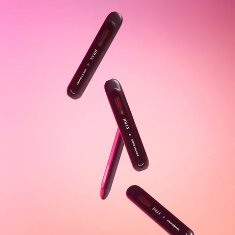 Lifestyle image of cbd disposables suspended in space, orange and pink background