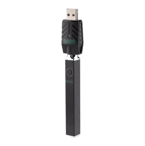 Ooze Quad 510 vape device in black with attached black USB charger.