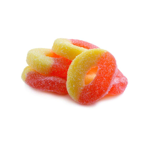 Lifestyle image of gummy rings on a surface. Orange and Yellow Colors