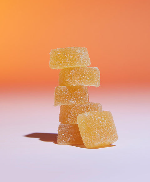 Lifestyle image of yellow gummies stacked on each other