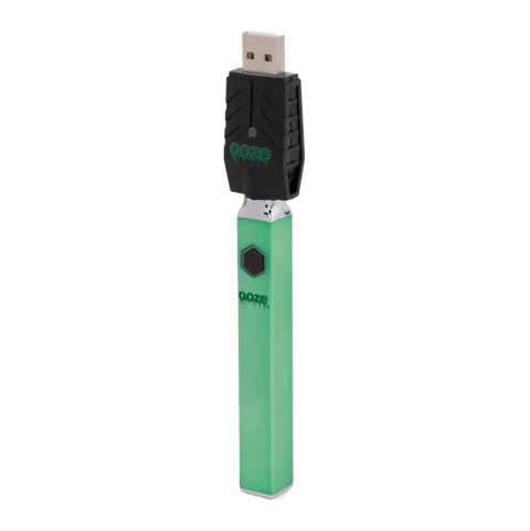 Ooze Quad 510 vape device in green with attached black USB charger.