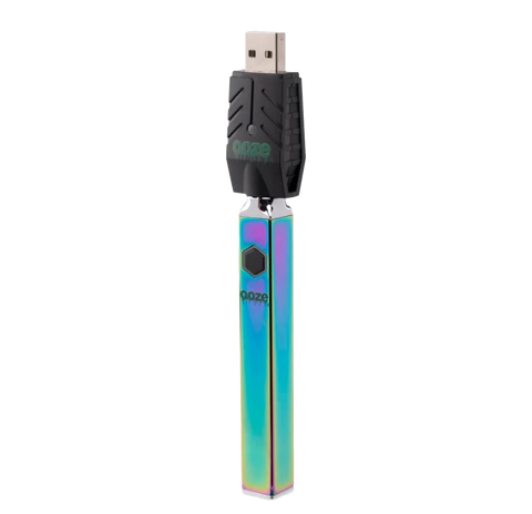 Ooze Quad 510 vape device in Rainbow with attached black USB charger.