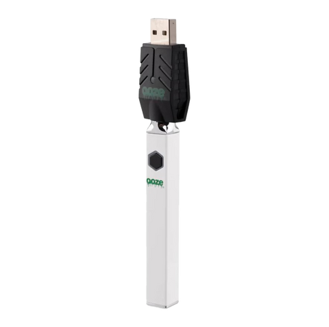 Ooze Quad 510 vape device in white with attached black USB charger.